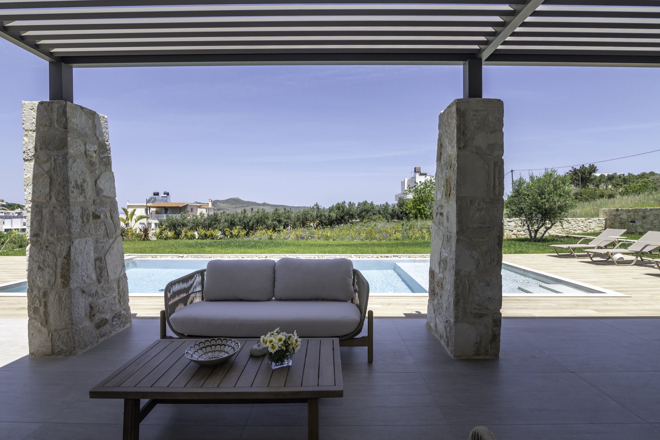 Covered pergola seating by the pool