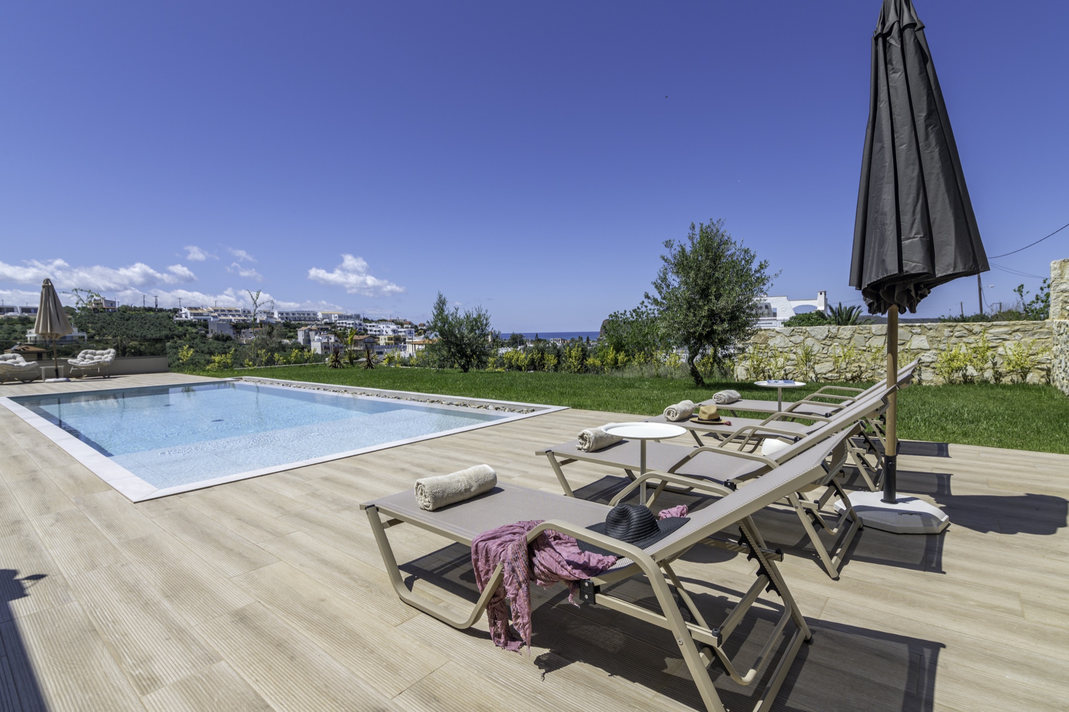 Poolside sun loungers with a sea view