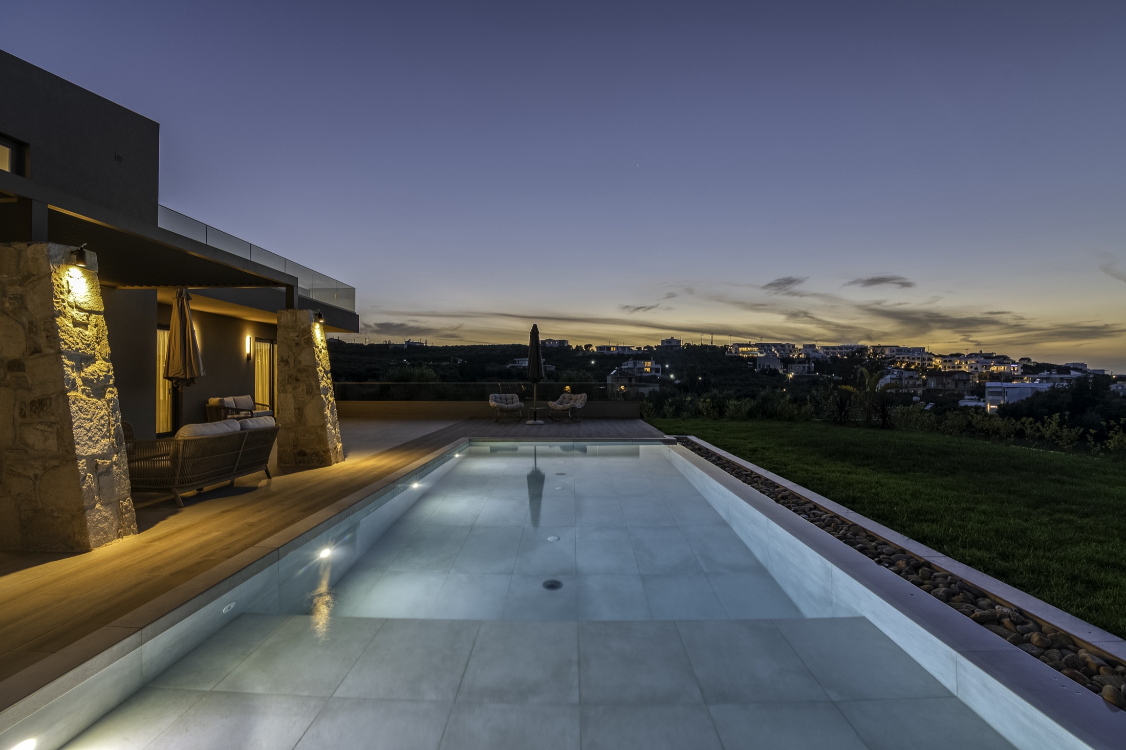 Greco Villa pool lit up at dusk