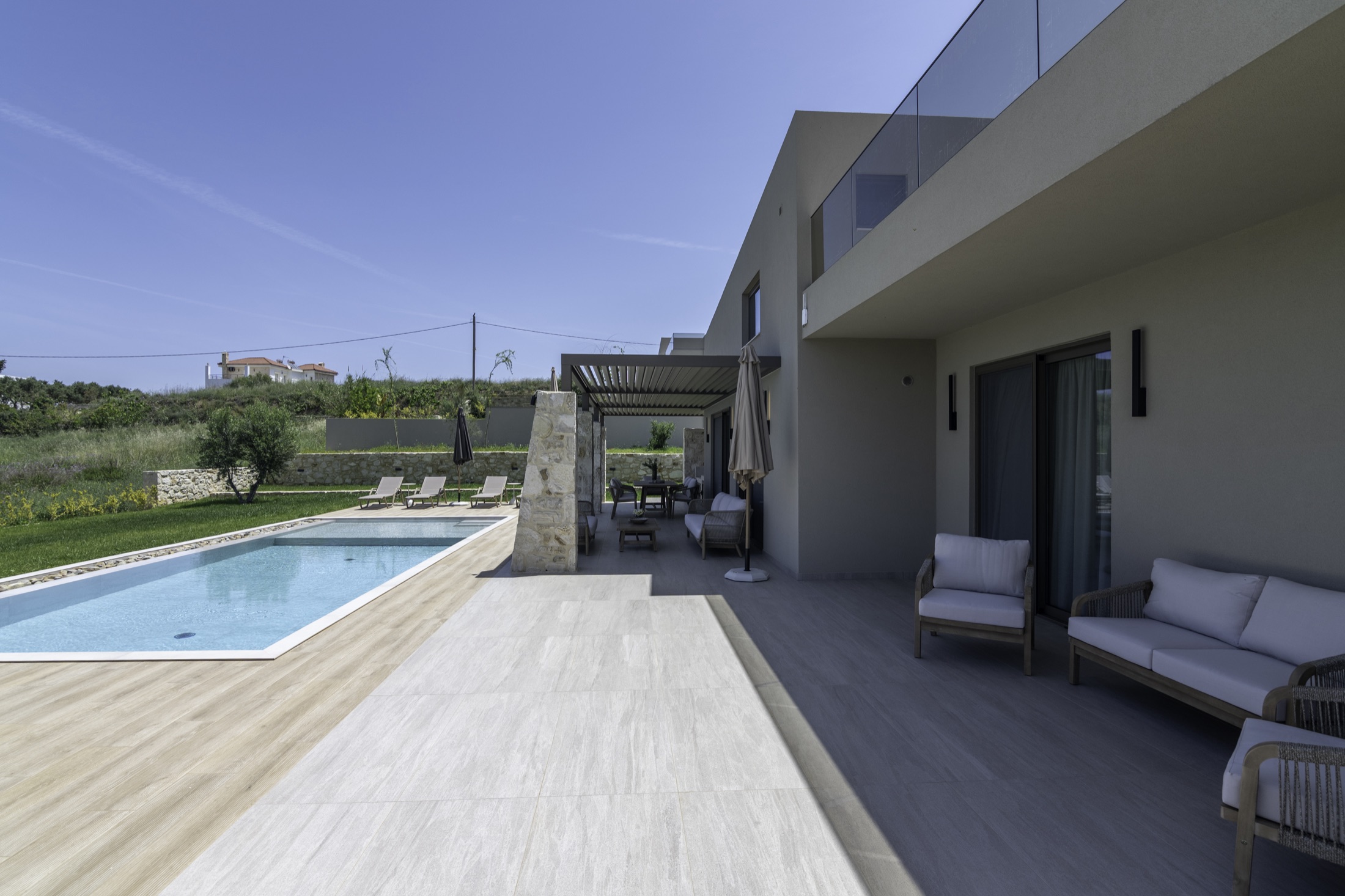 Covered terrace overlooking the pool and sea